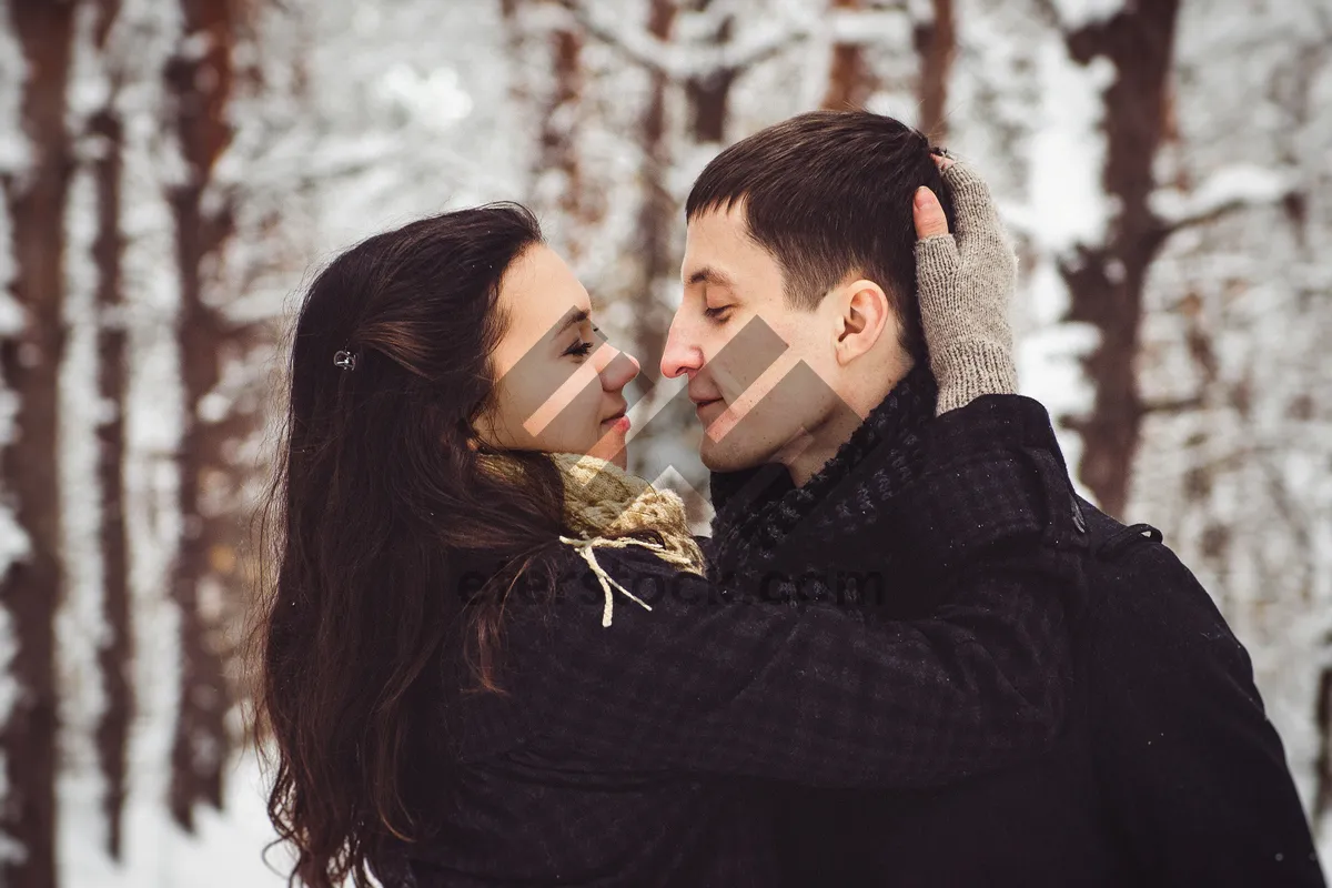 Picture of Happy couple smiling outdoors in romantic embrace.