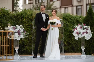 Smiling groom and bride celebrating love outdoors