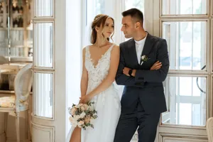 Successful business couple in wedding attire smiling happily.