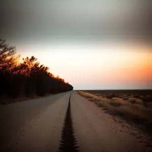 Golden Horizon: Sunset over Asphalt Road