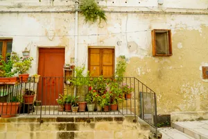 Residential building with old stone facade and balcony