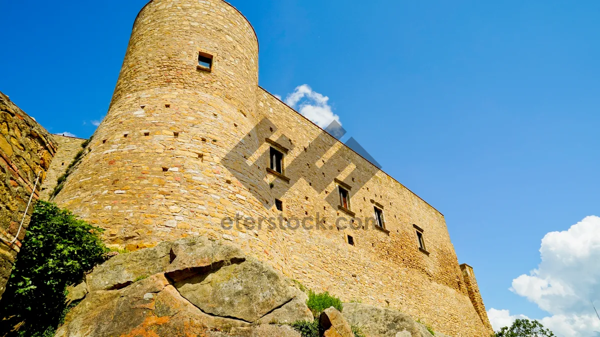 Picture of Medieval stone fortress against a blue sky.