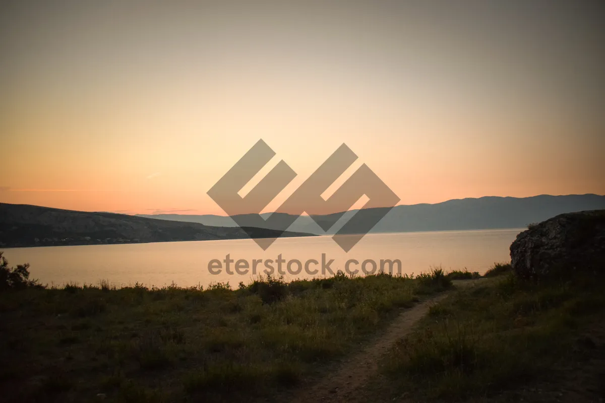 Picture of Sunset over mountain landscape with fields and trees