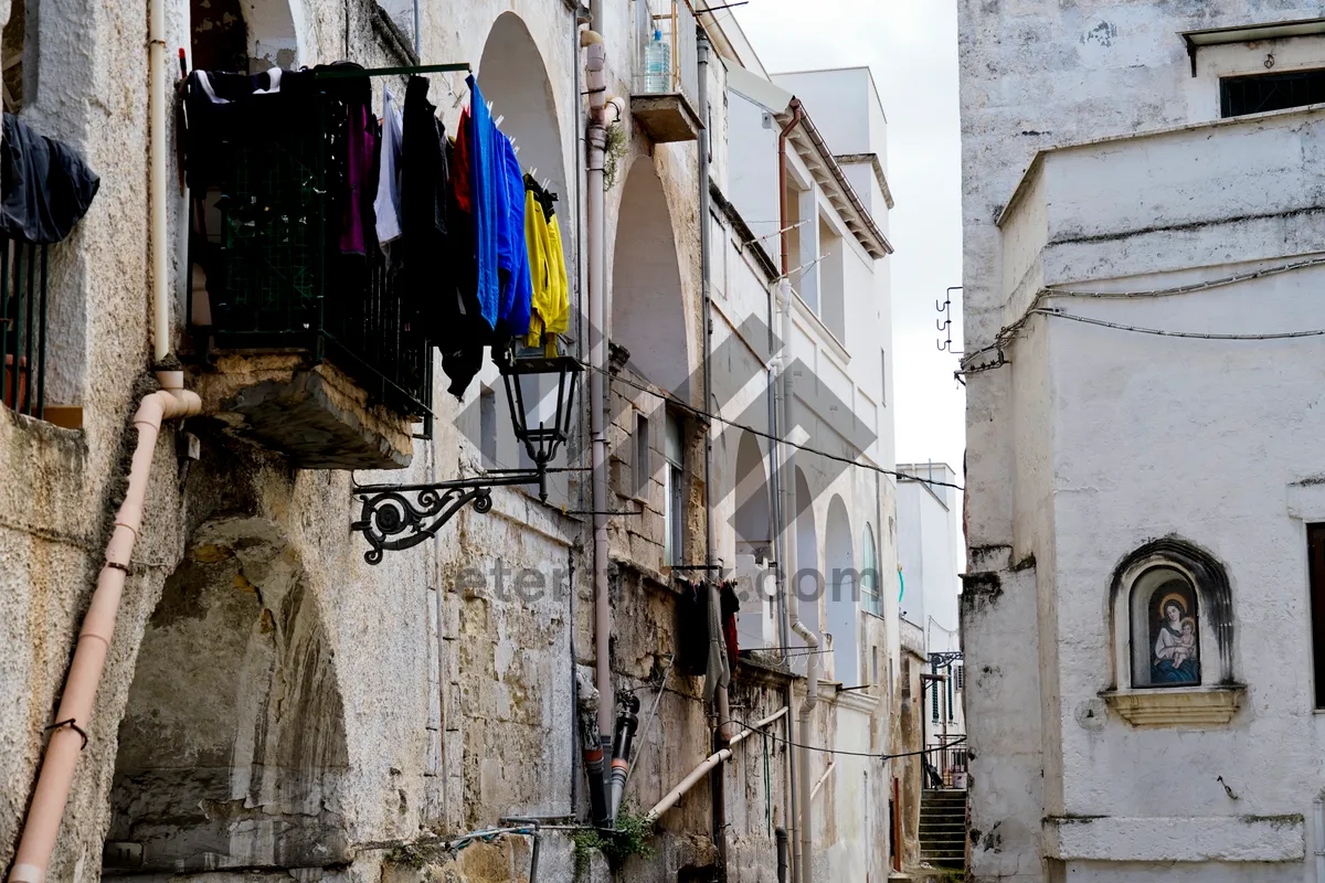 Picture of Old city buildings with windows and semaphore signal.