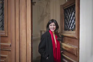 Smiling brunette businesswoman in professional trench coat