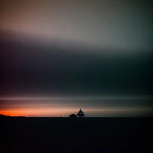 Orange Horizon over Ocean: Celestial Sunset Silhouette