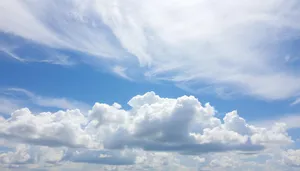 Vibrant sunny sky with fluffy clouds.