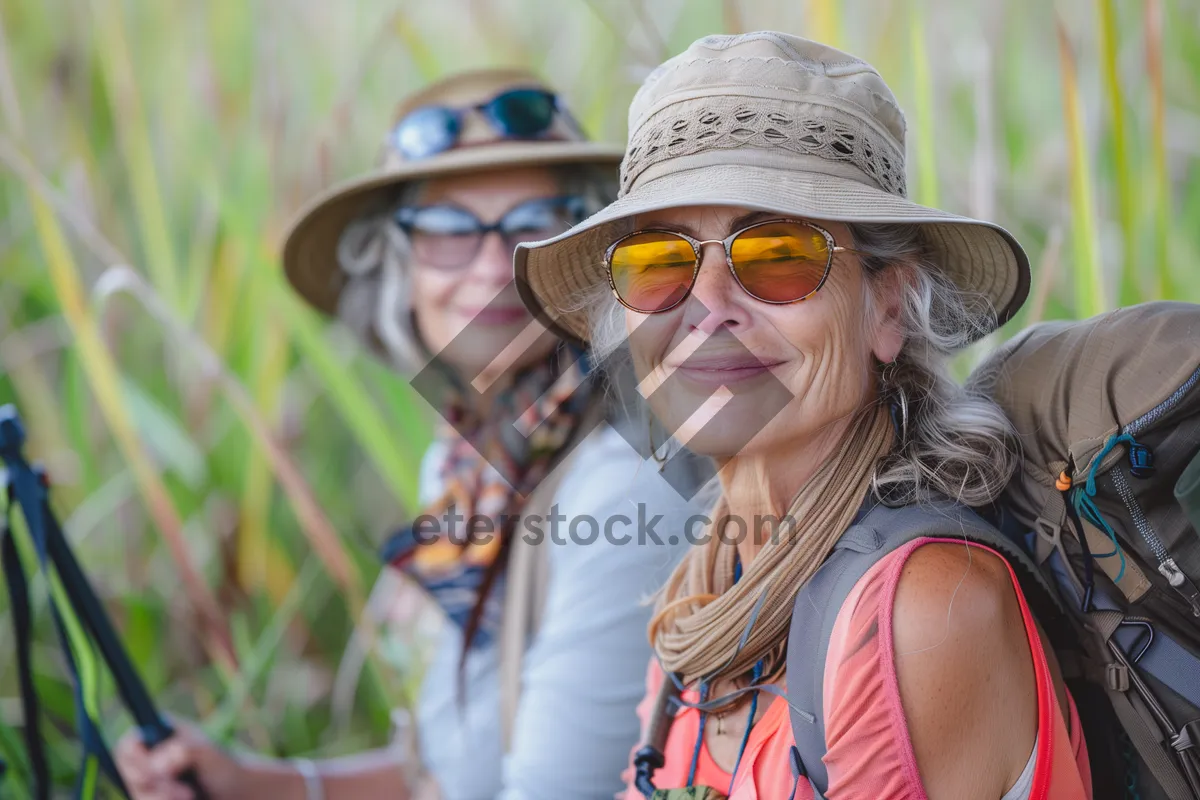 Picture of Happy Man in Sunglasses and Hat Smiling Outdoors