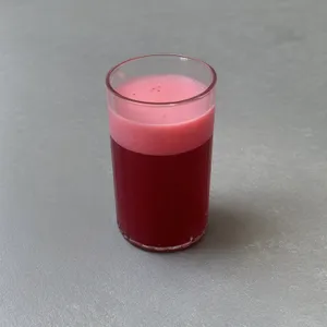 Fresh fruit smoothie in tall glass with ice cubes