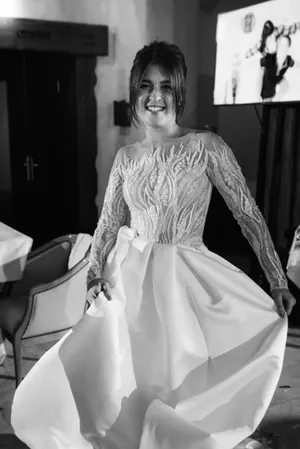 Happy bride in elegant wedding dress with bouquet