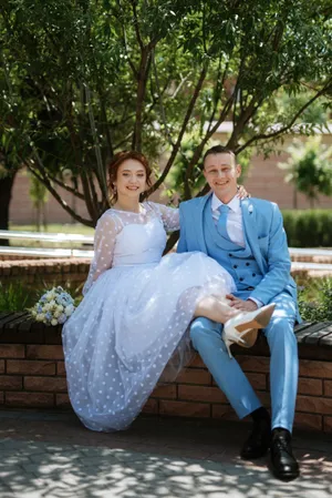 Happy couple in park on wedding day celebrate love.