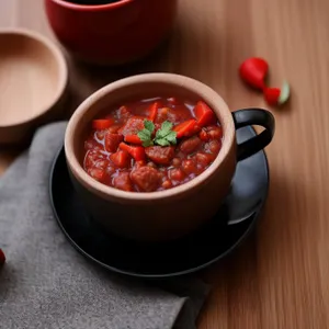 Delicious vegetable soup bowl with pepper and tomato.