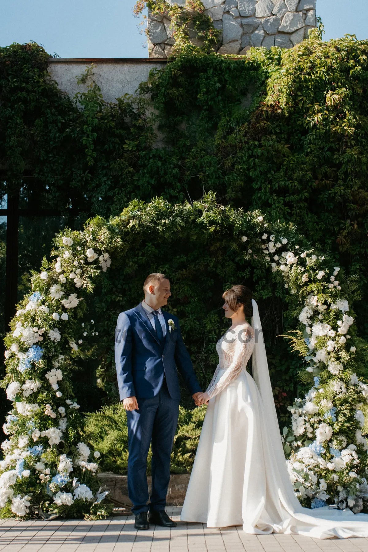 Picture of Happy bride and groom celebrating outdoors in park.