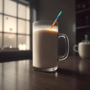 Coffee Cup on Saucer with Milk and Spoon