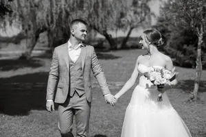 Happy Couple on Their Wedding Day Smiling Outdoors