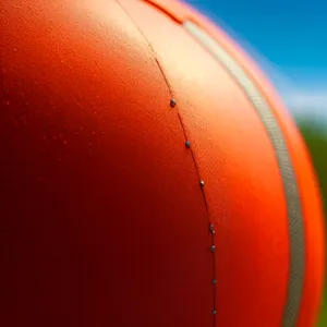 Sunlit Orange Sphere Balloon in Sports Competition