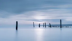 City skyline reflecting in water during sunset.