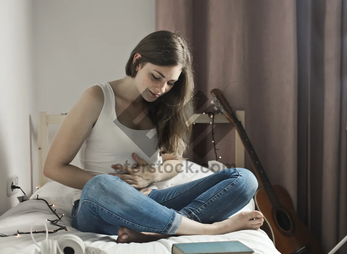 Picture of Happy woman smiling with laptop on sofa