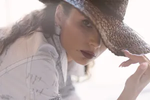 Attractive young woman in stylish cowboy hat smiling portrait.