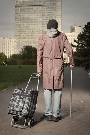 Man in trench coat walking outdoors in rain