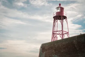 Coastal lighthouse shining beacon of safety