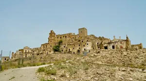 Ancient Castle Tower Among Historic Ruins at Sunset