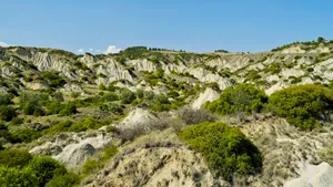 Mountain landscape with rocky slopes and lush valleys.