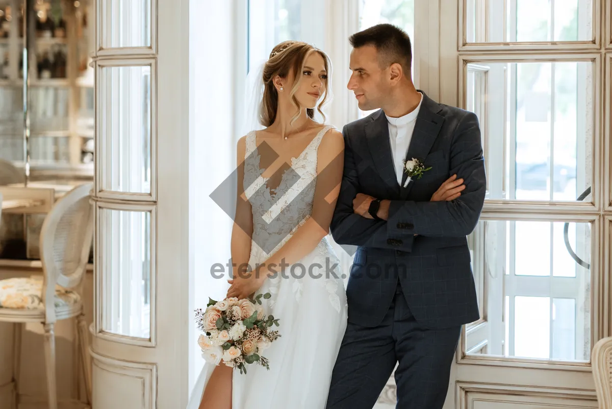 Picture of Successful business couple in wedding attire smiling happily.