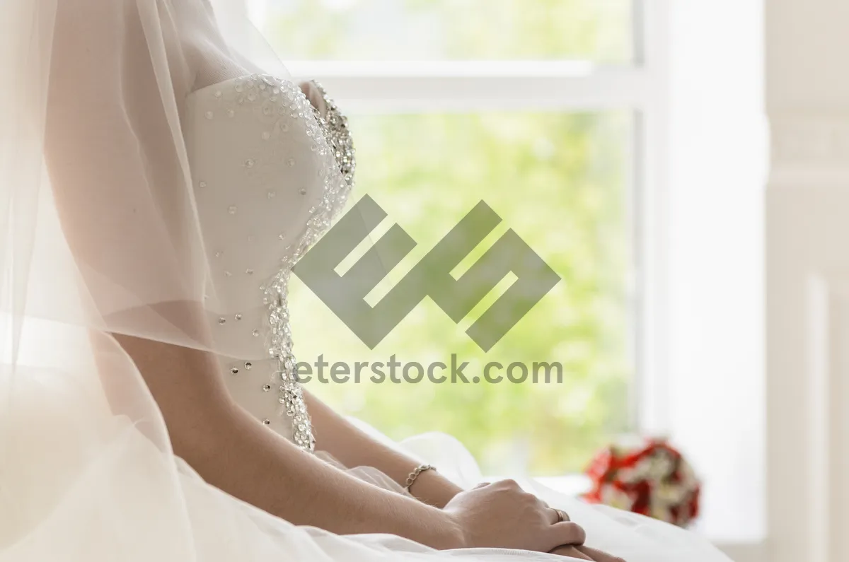 Picture of Attractive smiling bride portrait at home in spiritual attire.