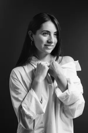 Smiling brunette businesswoman in black suit coat