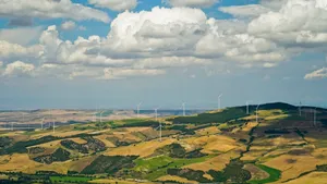 Summer Landscape with Rapeseed Fields and Wind Turbine