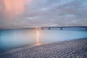 Relaxing sunset on tranquil beach overlooking ocean shore.