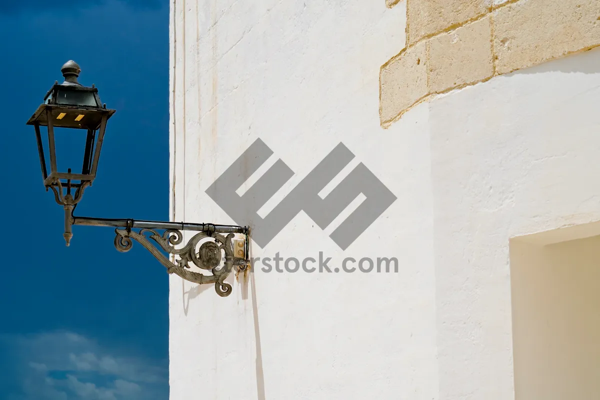 Picture of Old church tower with bell and stucco walls.