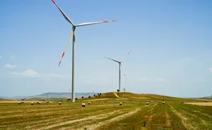 Sustainable energy: Wind turbine slicing through clean sky.