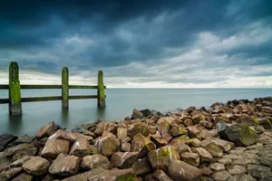 Coastal Breakwater: Summer Shoreline Structure On Beach.