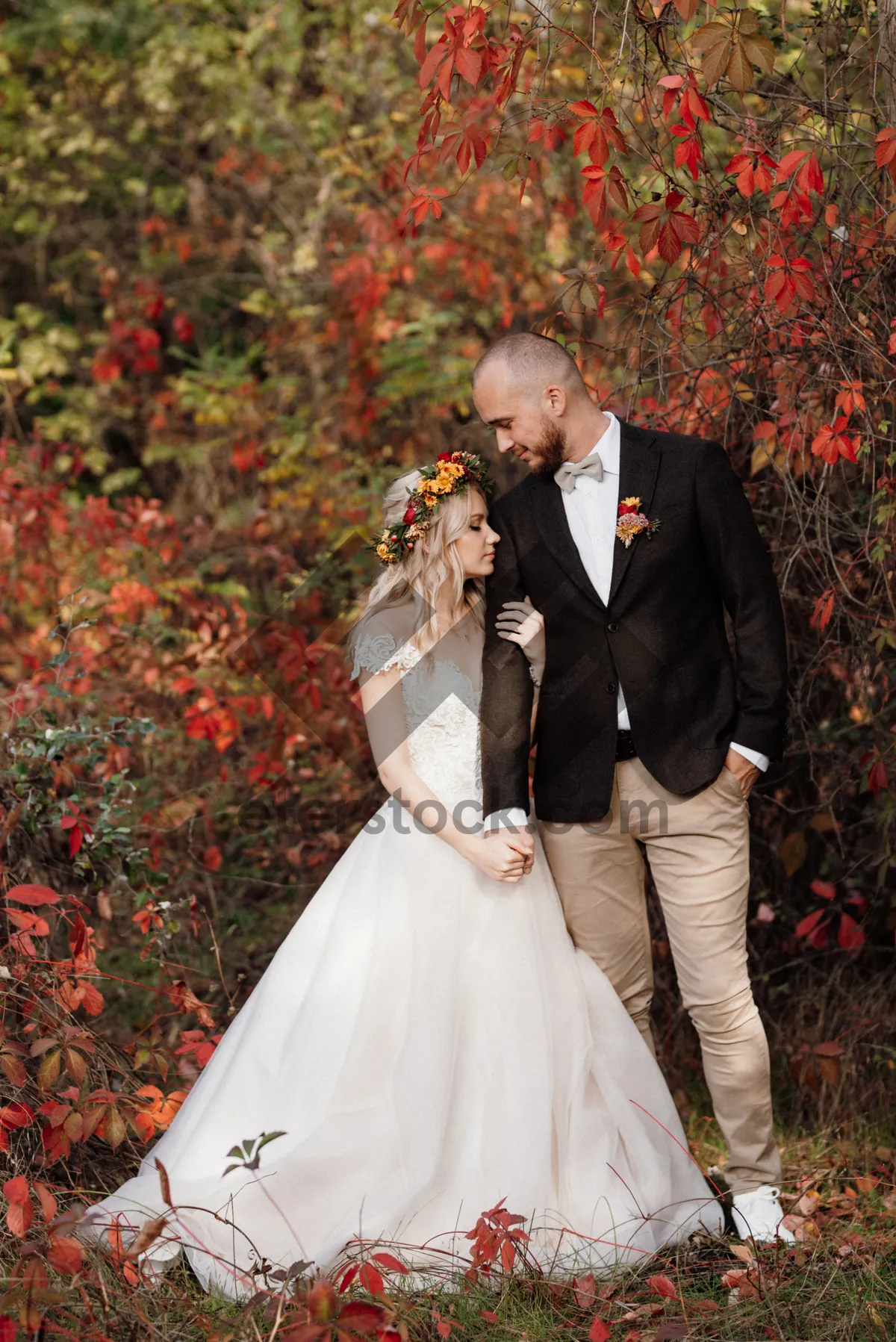 Picture of Happy Couple Celebrating Wedding Outdoors with Flowers