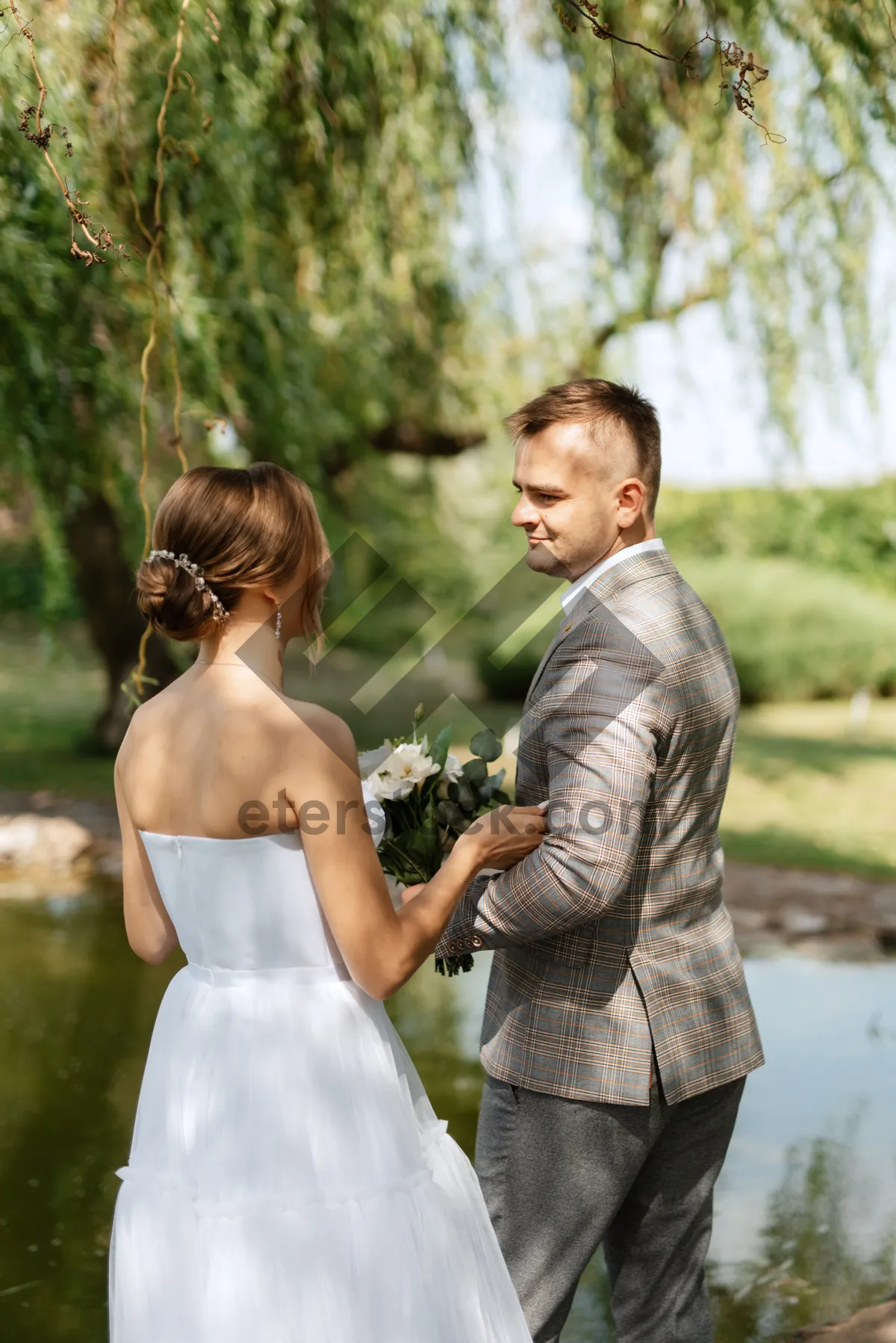 Picture of Happy couple in the park on their wedding day.