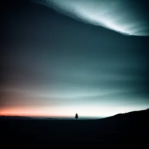 Vibrant Celestial Sunset Over Mountain Landscape