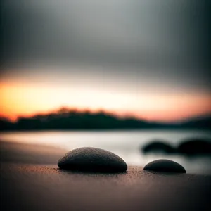 Tranquil Pebble Stack by the Reflecting Sun