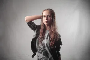 Attractive brunette fashion model posing in studio portrait.