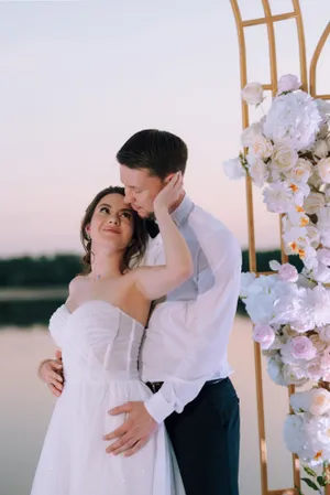 Smiling couple celebration outdoors wedding day flower bouquet.