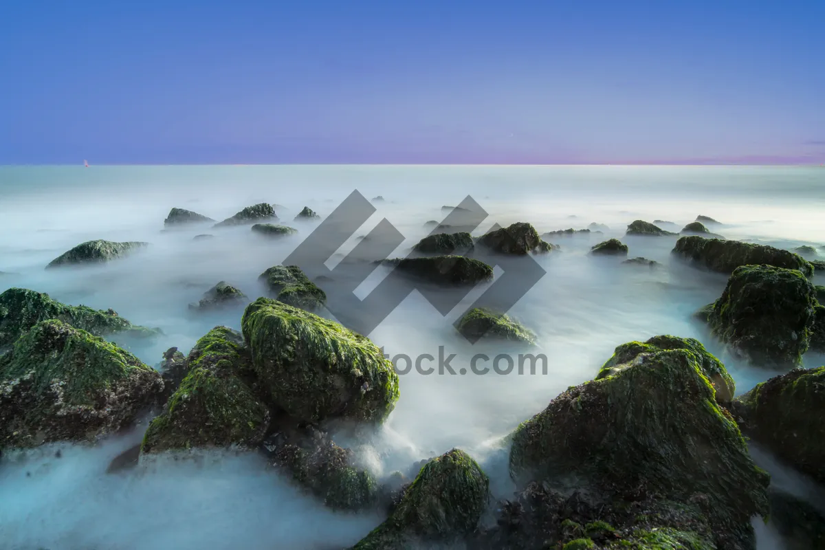 Picture of Tropical paradise beachscape with rocky coastline and crystal waters.