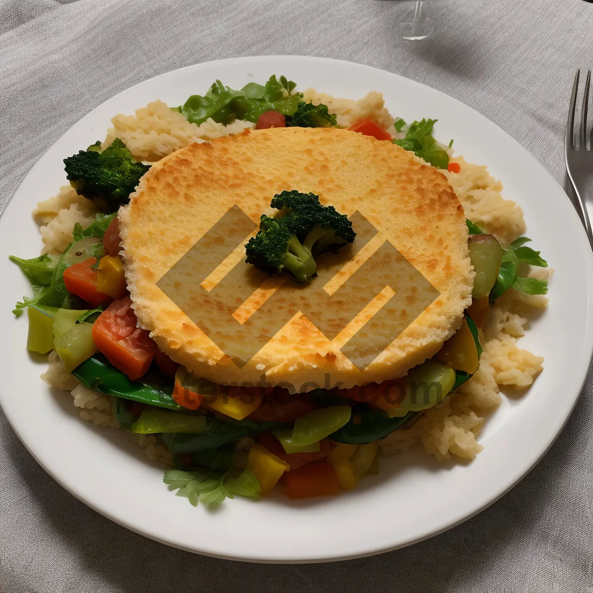 Picture of Gourmet meal with cheese, vegetables, and sauce