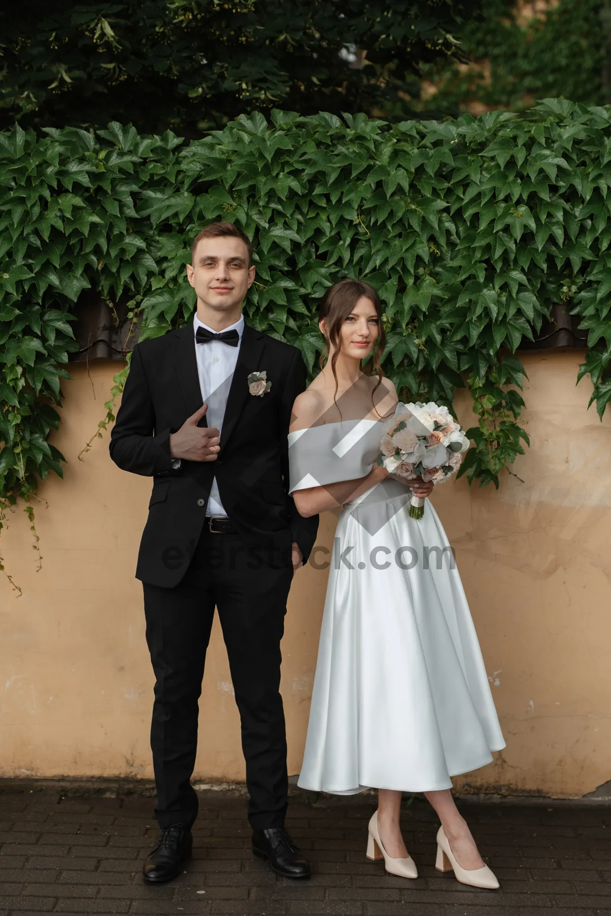 Picture of Smiling groom and bride celebrating their love outdoors