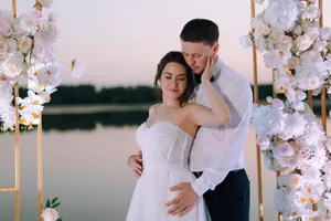 Happy couple celebrating their wedding day outdoors with flowers