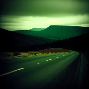 Serene countryside drive under cloudy skies