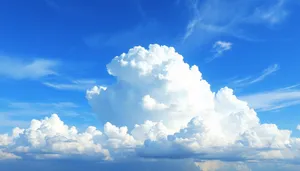 Bright sunny sky with fluffy white clouds.