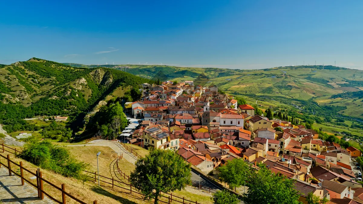 Picture of Scenic town with castle on hill overlooking river.