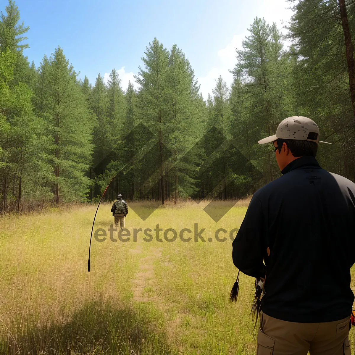 Picture of Adventurous hiker with bow and arrow in scenic mountain landscape