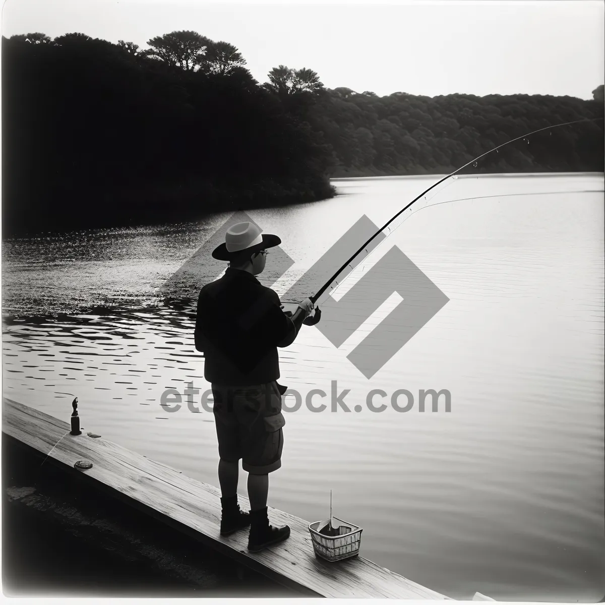 Picture of Summer Fisherman Reeling in Catch on Lake